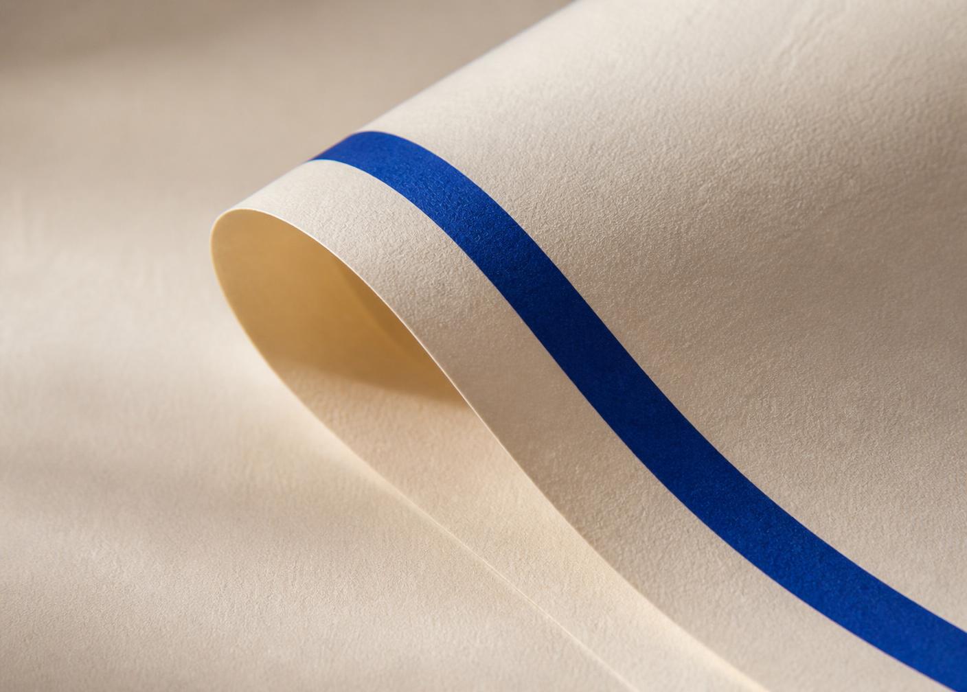 Cream paper folded in daylight with a royal blue printed band